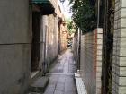 Traditional transportation through a tiny alleyway in Guangzhou