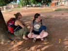 Laughing at nosy chickens with Eva while waiting for our mototaxi drivers to arrive