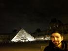 A nighttime picture of myself in front of the Louvre Pyramid