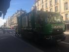 Garbage trucks in Paris are big and green, but not too big to fit down the narrow streets.