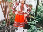 Here is Antonia wearing traditional Romanian clothing in her garden