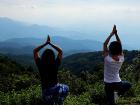 Doing the Tree Pose at a viewpoint in Doi Inthanon
