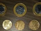 The larger coins in the picture are 1 real. The smaller coins are 10 centavos (cents). How much do I pay to ride the bus?