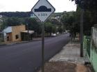 Many streets in Brazil have speed bumps to watch out for, even if you're walking. This sign tells me there is a speed bump 50 meters ahead. How many feet is that?