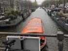 A boat passing under a canal bridge