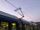 City trams are connected to the electric cables to get them the power to run