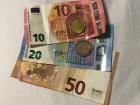 Colorful euro bills and coins