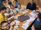 Making snacks with the kids using crackers, ham and jam