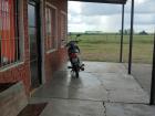 The cook/ custodian's motorcycle parked outside of the elementary school