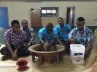 Men of the Cuvu Village preparing kava during a Kalevu i-sevusevu ceremony