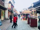 Trying free food samples on a historical street