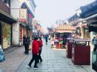 Trying free food samples on a historical street