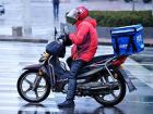 Deliverymen in China go around on e-bikes--note the blue box where he stores all the food