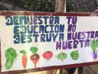 This mural says "Demonstrate education—you don't destroy our garden"
