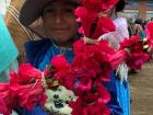 Hubernal holding the flower cross that he made at La Fiesta de la Cruz in the town nearby
