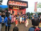 There children from a local small school are performing traditional dances and games at a festival