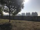 Before: Apartment buildings overlook an empty field