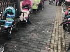 Strollers parked outside the nearby preschool as parents and grandparents wait for the schoolday to end