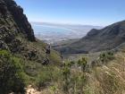 You can see a lot of different landscapes in this photo like the mountains and the body of water