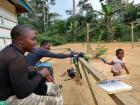 Fabrice shares our biscuits with a child in Alait Makai 