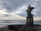 A statue of a Hindu god on the beach in Bali