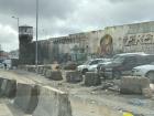 The black areas along the wall and watchtower is a common spot where people burn trash at Qalandia Checkpoint