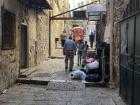 Small trucks that fit through the narrow streets of the Old City pick up and transport trash 