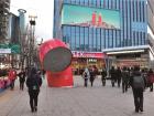 The big, red straw-like statue next to the subway exit