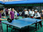 Volunteers play table tennis with senior citizens