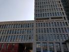 Tall buildings overlook the school