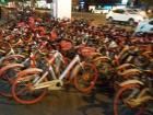 Hordes of available bicycles on the sidewalk for anyone to use