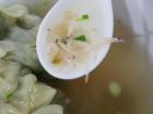 The wonton soup stock includes veggies and a lot of tiny shrimp