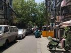 A block from the school the street is lined with restaurants and barbershops