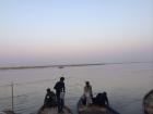 Men prepare to row out into the Ganga (or Ganges), a river sacred to Hindus