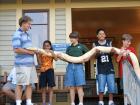 Nine-year-old Deepa (in the orange shirt) is holding a large snake