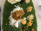 A traditional South Indian meal of rice and various sauces, served on a banana leaf