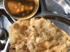 Poori or bhatura, a type of puffed fried bread served with chickpeas 