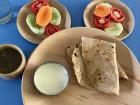 A meal of chapatis, yogurt and vegetables