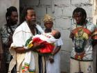 Many family and friends attend this event (https://www.easytrackghana.com/images/photos/A%20rastafarian%20priest%20with%20a%20newly-born%20child.jpg)