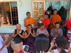 These monks are pouring blessed water on the elders before they are bathed by their families