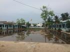 During the rainy season, the main yard at Trân and Trúc's school floods