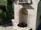 A fountain outside of the church. The water was constantly running from a well below the surface