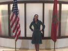 At an embassy event, standing between the American and Moroccan flags