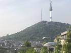 Namsan Seoul Tower overlooks the city from the top of a mountain