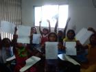 The kids proudly showing off their drawings of the day