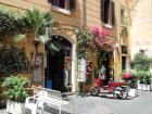 Because Rome is an old, urban environment, there aren't a lot of places for trees and natural things. Roman citizens make their own nature by growing small gardens in their window boxes and decorating the buildings with flowers and vines 