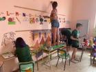 Me and some of my classmates painting murals on the classroom walls