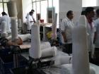 Workers ready to mold plastic around replicas of patients' stumps