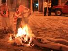 A man burning his old year doll