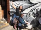 Posing next to a zebra painting. Fun Fact, The Zebra is Botswana's Animal.